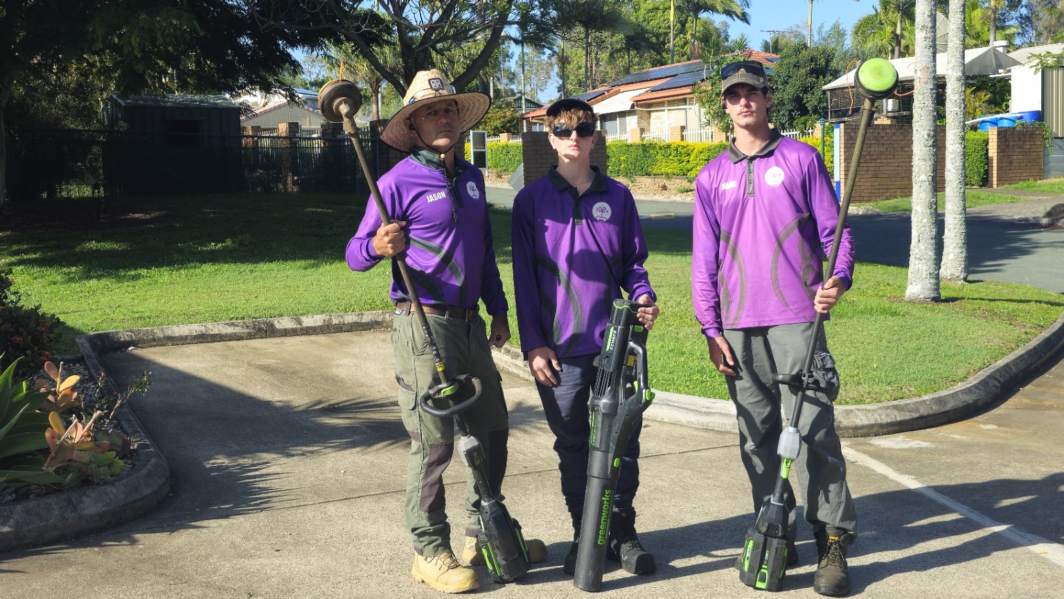 Three Excel Grounds Maintenance team members with their tools