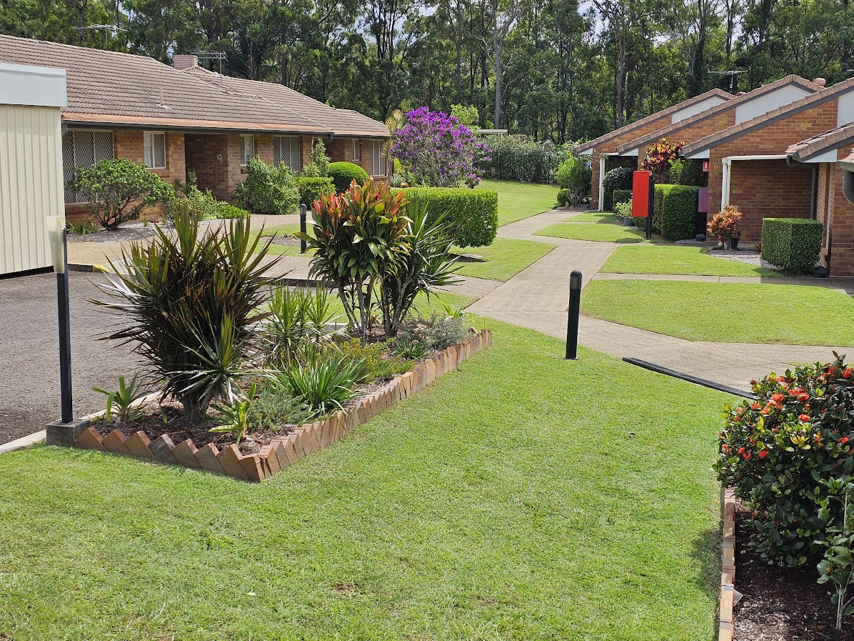 Maintained lawns, garden beds and paths between retirement village homes